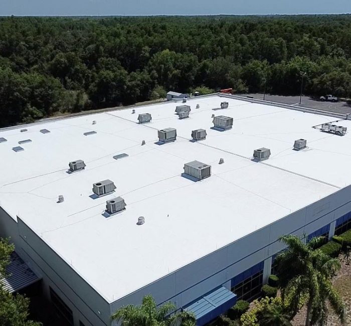Aerial view of a clean white commercial building roof.