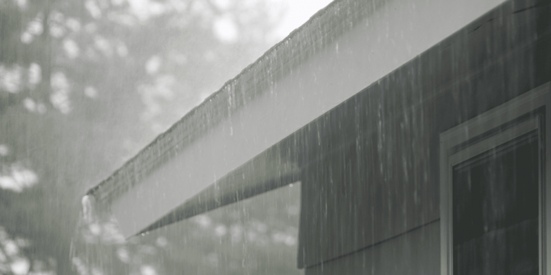 heavy rain falling on a residential roof